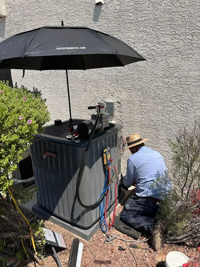 HVAC technician performing outdoor AC maintenance in Holden